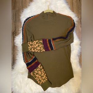 Free People sweater size Large crochet on the sleeve beautiful sweater.